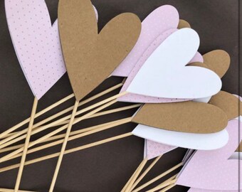 Heart made of colored cardboard on a wooden pick to decorate a ceremonial aisle at a wedding or baptism or event