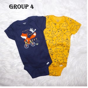 May include: Two baby onesies, one navy blue with a fox riding a bicycle and the text "today is a fun day", and one yellow with a repeating pattern of foxes.
