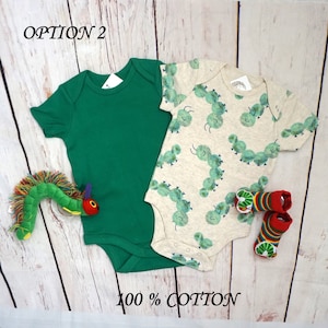 May include: Two baby onesies, one green and one with a white background and a green caterpillar pattern. The text "OPTION 2" is in the top left corner of the image. The text "100% COTTON" is in the bottom center of the image.