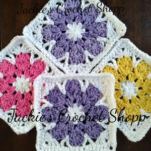 May include: Four crocheted flower squares in pink, purple, yellow, and white. The squares are joined together to form a larger piece. The text "Jackie's Crochet Shopp" is visible in the image.