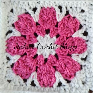 May include: A pink and white crochet flower square with the text "Jackie's Crochet Shop" in the center.