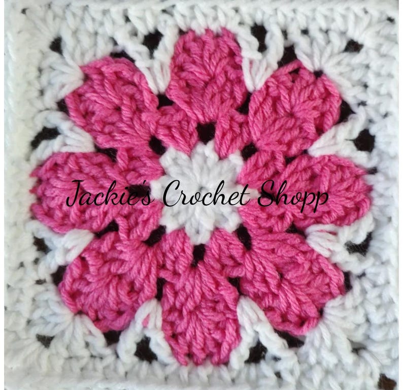 May include: A pink and white crochet flower square with the text "Jackie's Crochet Shop" in the center.
