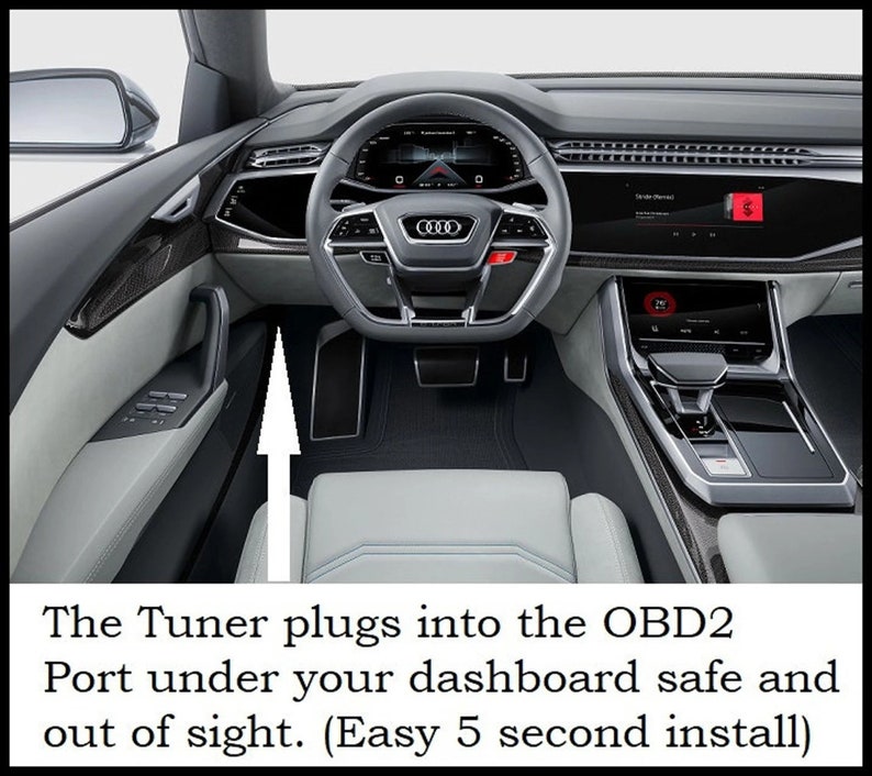 May include: A close-up of the interior of a car with a white leather seat and a black dashboard. An arrow points to the OBD2 port under the dashboard, where a tuner can be plugged in.