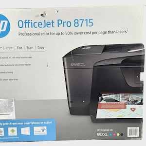 May include: A black HP OfficeJet Pro 8715 printer on a white background. The box includes the HP logo, product name, and features like wireless printing, a 2.65-inch touchscreen, and a 250-sheet input tray. The box also mentions the printer's ability to print from a smartphone or tablet.