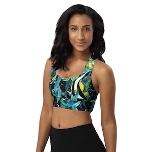 May include: A black sports bra with a colorful tropical fish print. The print features blue, green, yellow, and white fish on a black background.