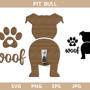 May include: A brown wooden cutout of a pit bull dog with the word "woof" written below it. The dog has a heart-shaped paw print on its back and a metal hook for hanging. The image also includes a black silhouette of the dog and a paw print with the word "woof" written below it.