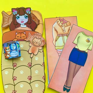 Druckbare Papierpuppe Katze mit Schlafsack, Spielzeug und Outfits, Anziehbild, Basteln für Kinder, Digitaler Download