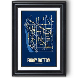 May include: Framed print featuring a stylized map of the Foggy Bottom neighborhood in Washington, D.C. The map is in shades of blue and beige, with street names and landmarks labeled. The text "FOGGY BOTTOM WASHINGTON DC" is at the bottom.