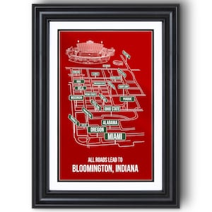 May include: Framed print with a red background featuring a white line drawing of a map with various college names. The text "ALL ROADS LEAD TO BLOOMINGTON, INDIANA" is at the bottom. The frame is black.
