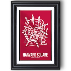 May include: Framed print of a map of Harvard Square, Massachusetts, in white on a red background. Street names are labeled. The frame is black. The text "HARVARD SQUARE MASSACHUSETTS" is at the bottom.