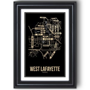 May include: Framed black and gold map print of West Lafayette, Indiana. The map features street names such as State St, Stadium Ave, and Airport Rd. The words "West Lafayette Indiana" are printed at the bottom of the map.