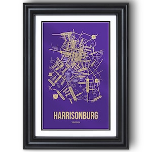 May include: Framed map print of Harrisonburg, Virginia, in gold on a purple background. The map details streets and landmarks, with the city name and state at the bottom. The print is encased in a black frame.