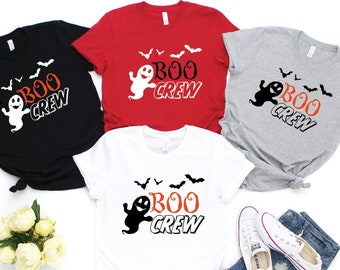 May include: Four t-shirts with a ghost and bats graphic and the text "BOO CREW". The shirts are in black, red, grey, and white.