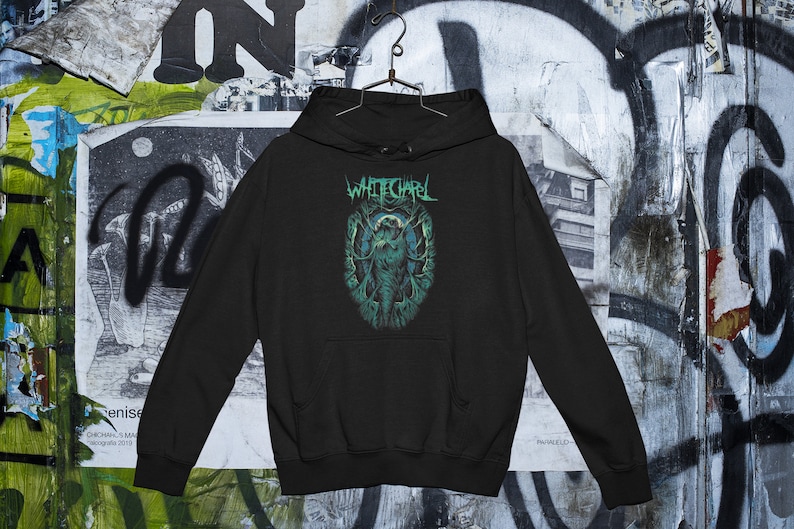 May include: Black hooded sweatshirt with a green and white graphic print of a creature with the text "Whitechapel" above it.