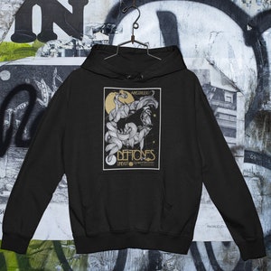 May include: Black hooded sweatshirt with a graphic print of a band called "Deftones" with the words "Angerized" and "Live" printed on the graphic.