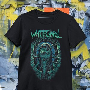 May include: Black t-shirt with a green and white graphic of a creature with the band name "Whitechapel" printed in white.