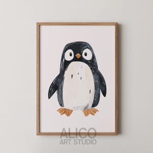 May include: A framed print of a cartoon penguin with a black and white body and orange feet. The penguin is looking directly at the viewer. The frame is made of wood and has a light brown finish. The print is titled "ALICO ART STUDIO".