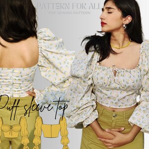 May include: A white puff sleeve top with a floral print. The top has a square neckline and a gathered detail at the neckline. The sleeves are gathered at the shoulders and have a puff shape. The top is cropped and has a fitted bodice.