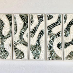 May include: Five-panel wall art with a repeating pattern. Each panel features a white background with a flowing, organic design in shades of green and silver, framed in a light gray.