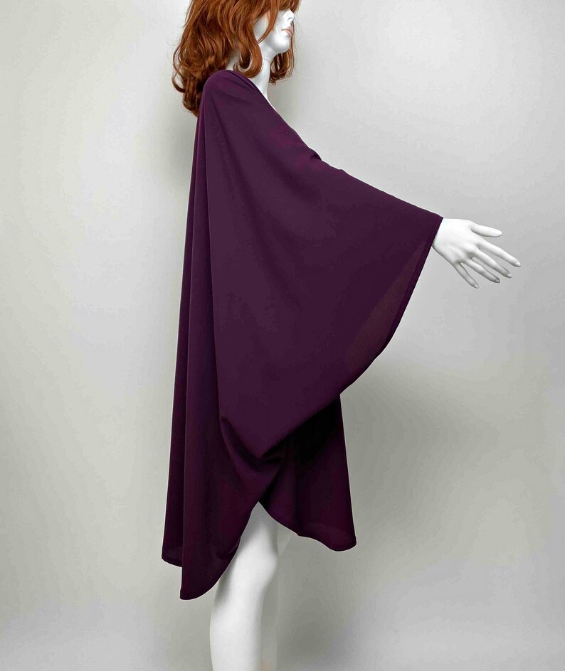 May include: A long, flowing, purple kimono-style top with wide sleeves. The top is made of a soft, lightweight fabric and has a relaxed fit.