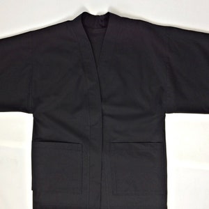 May include: A black, long-sleeved jacket with a V-neck and two pockets.