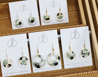 May include: Four pairs of green, black, and gold round dangle earrings displayed on white cards with the text "Etsy Shop: Lillabjerke" and "www.etsy.co.uk/shop/lillabjerke".