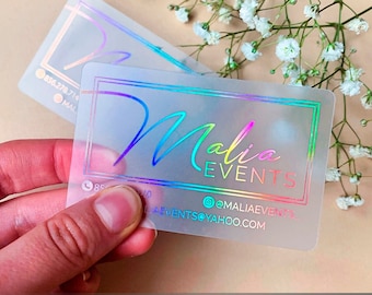 May include: Frosted transparent plastic business cards with neon foil accents. The text on the card reads "Malia Events" with a phone number and email address.
