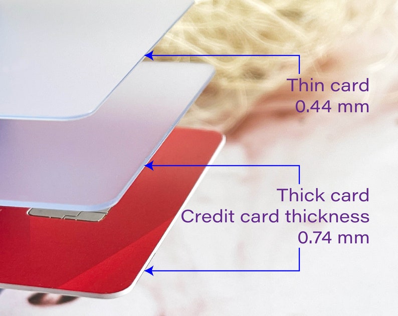 May include: Close-up of three layers of plastic cards, showing the thickness of a standard credit card, which is 0.74 mm, and a thinner card, which is 0.44 mm.