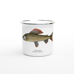 May include: White enamel mug with a grayling fish illustration. The fish has a red and orange fin and is outlined in black. The text below the fish reads "Grayling - Thymallus thymallus - "