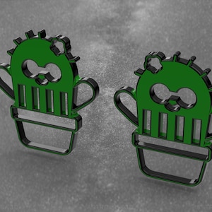 Pode incluir: Dois ícones 3D em forma de cacto, pretos e verdes, com um rosto sorridente e uma flor no topo. Os ícones estão em um fundo cinza.
