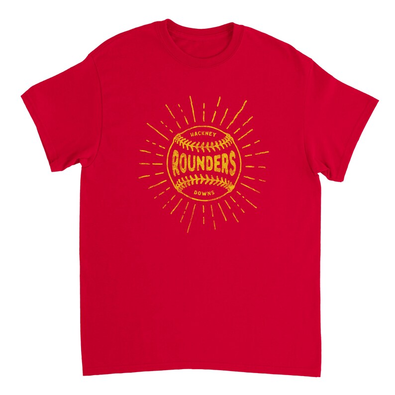 May include: A bright red short-sleeved t-shirt featuring a yellow graphic of a baseball with the text "HACKNEY ROUNDERS DOWNS" printed in the center. The design includes radiating lines extending outward from the ball in a sunburst pattern.