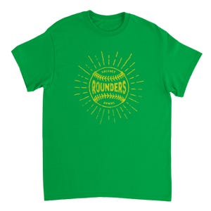 May include: A bright green short-sleeve t-shirt featuring a yellow graphic of a baseball with the text "HACKNEY ROUNDERS DOWNS" printed across the center. The design includes radiating lines extending outward from the ball in a sunburst pattern.