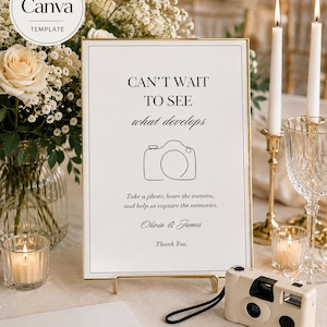 May include: A rectangular wedding sign in a gold frame featuring the text CAN'T WAIT TO SEE what develops, a line-art camera icon, and the names Olivia & James. The sign includes instructions to take a photo and leave the camera.