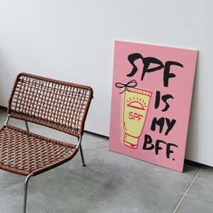 May include: Pink canvas print with a black and white illustration of a tube of sunscreen with the text "SPF is my BFF."
