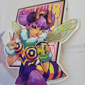 May include: A sticker featuring a cartoon bee-themed character with purple hair and wings, holding a boba tea. The character is wearing a purple and yellow outfit and making a peace sign. The sticker has the text "Bumble Bee B" and "khubarb moyd.com".