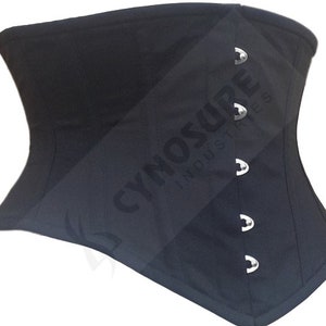 May include: Black corset with silver eyelets and the text "CYNOSURE INDUSTRIES" printed on the fabric.