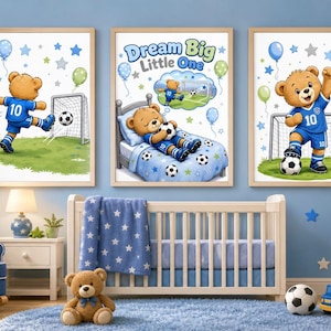 May include: Three framed wall art prints featuring a brown teddy bear wearing a blue football uniform with the number 10. The centre print shows the bear sleeping in a bed with the text Dream Big Little One, while the others show the bear playing football.