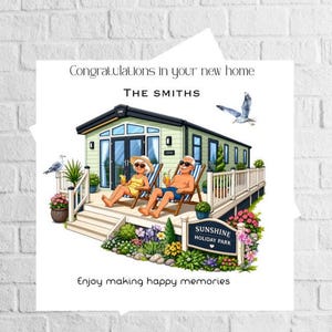 May include: A square greeting card featuring a light green mobile home with a wooden deck. Two people sit in lounge chairs on the deck. Text reads: Congratulations in your new home, THE SMITHS, SUNSHINE HOLIDAY PARK, and Enjoy making happy memories.