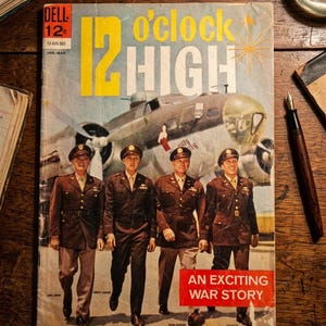 May include: A vintage Dell comic book titled 12 O'Clock High featuring a large illustration of a military aircraft and four individuals in brown military uniforms standing in front of it. The cover includes the text An Exciting War Story.