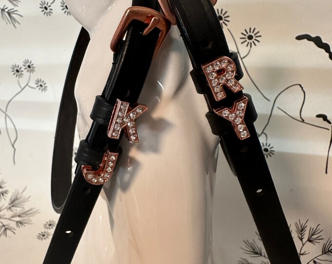 Black English leather spur straps with rose gold buckles and rose gold letters