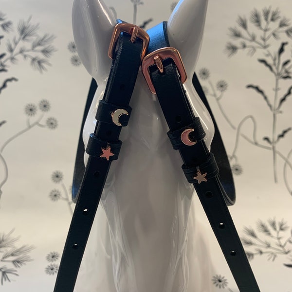Black English leather spur straps with rose gold buckles and rose gold moon and stars charms