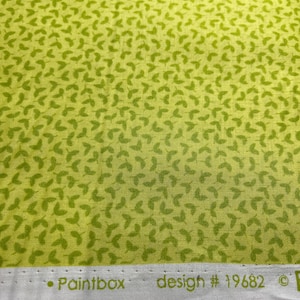May include: A close-up of a green fabric with a repeating pattern of small green leaves. The fabric has a white border with the text "Paintbox design # 19682 ©"