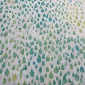 May include: White fabric with a repeating pattern of green and blue raindrops.