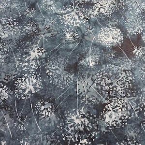 May include: A fabric with a repeating pattern of white dandelion seed heads on a dark blue and gray background. The dandelion heads have a textured appearance, and the stems are thin white lines. The overall effect is a soft, natural design.