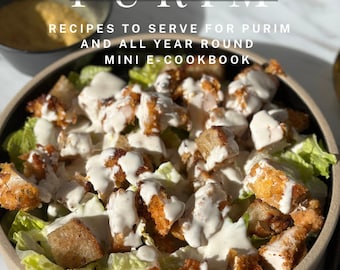 May include: A close-up of a bowl of salad with croutons, lettuce, and a creamy dressing. The text "Let's Talk About Purim" and "Recipes to Serve for Purim and All Year Round Mini E-Cookbook" is displayed above the salad. The text "Recipes by Sarah Cowen" is displayed below the salad.