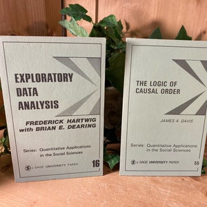 May include: Two green paperbacks with black text. The book on the left is titled "Exploratory Data Analysis" by Frederick Hartwig with Brian E. Dearing. The book on the right is titled "The Logic of Causal Order" by James A. Davis. Both books are part of the "Quantitative Applications in the Social Sciences" series and are Sage University Papers.