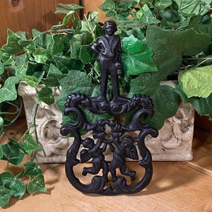 Vintage Black Cast Iron Cupid Trivet | Midcentury Modern Wall Decor | Shabby Chic Kitchen Wall Decor | Black Cast Iron Kitchen Trivet