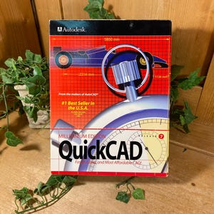 May include: A box of QuickCAD Millennium Edition software. The box is red with a diagram of a race car and the Autodesk logo. Text includes "#1 Best Seller in the U.S.A." and "Fast, Easy, and Most Affordable CAD!"