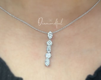 May include: A silver chain necklace with a pendant featuring a vertical row of five clear diamonds.