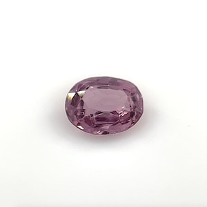 May include: A light purple oval-shaped gemstone with a faceted cut.